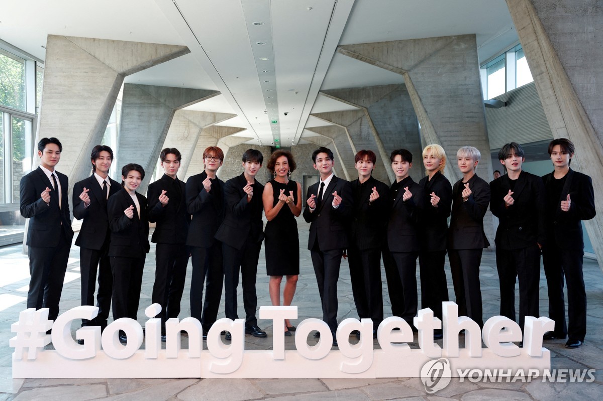 K-pop boy group Seventeen and UNESCO Director-General Audrey Azoulay pose for a photo before its nomination ceremony as Goodwill Ambassador for Youth at the UNESCO headquarters in Paris on June 26, 2024, in this Reuters photo. (Yonhap)
