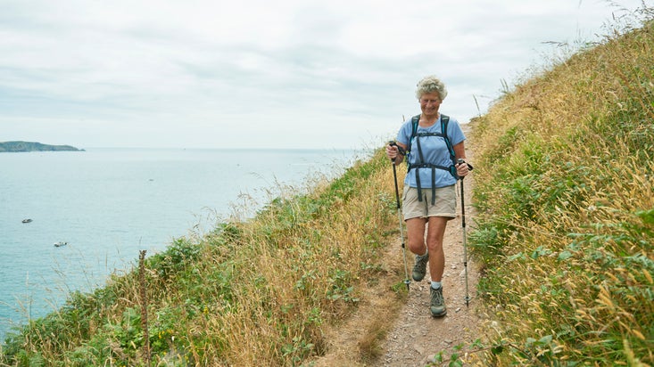 A person walking along the South West Coast Path at East Soar, South Devon