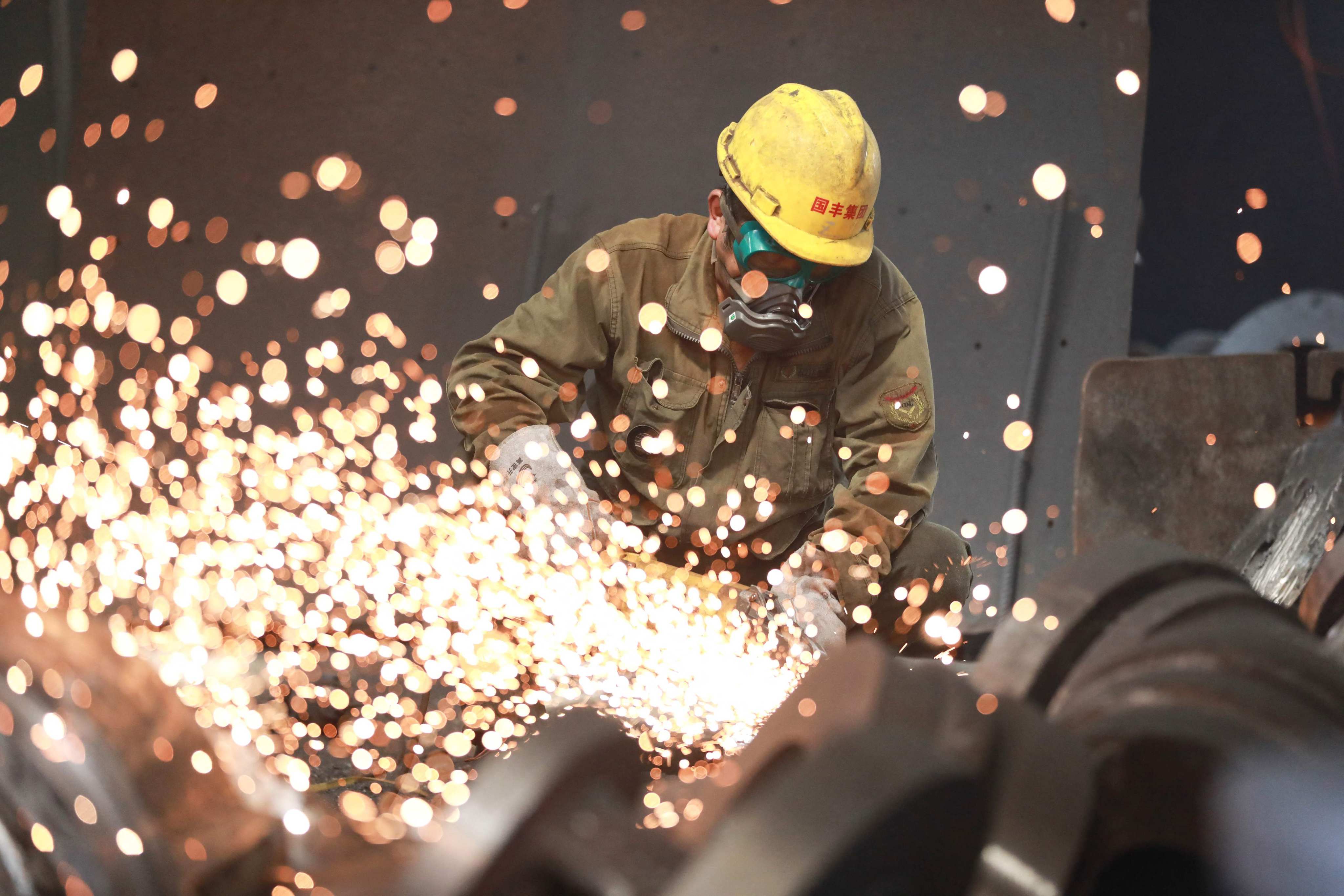 A worker welds metal at a factory in Hangzhou in China’s eastern Zhejiang province in June. Photo: AFP