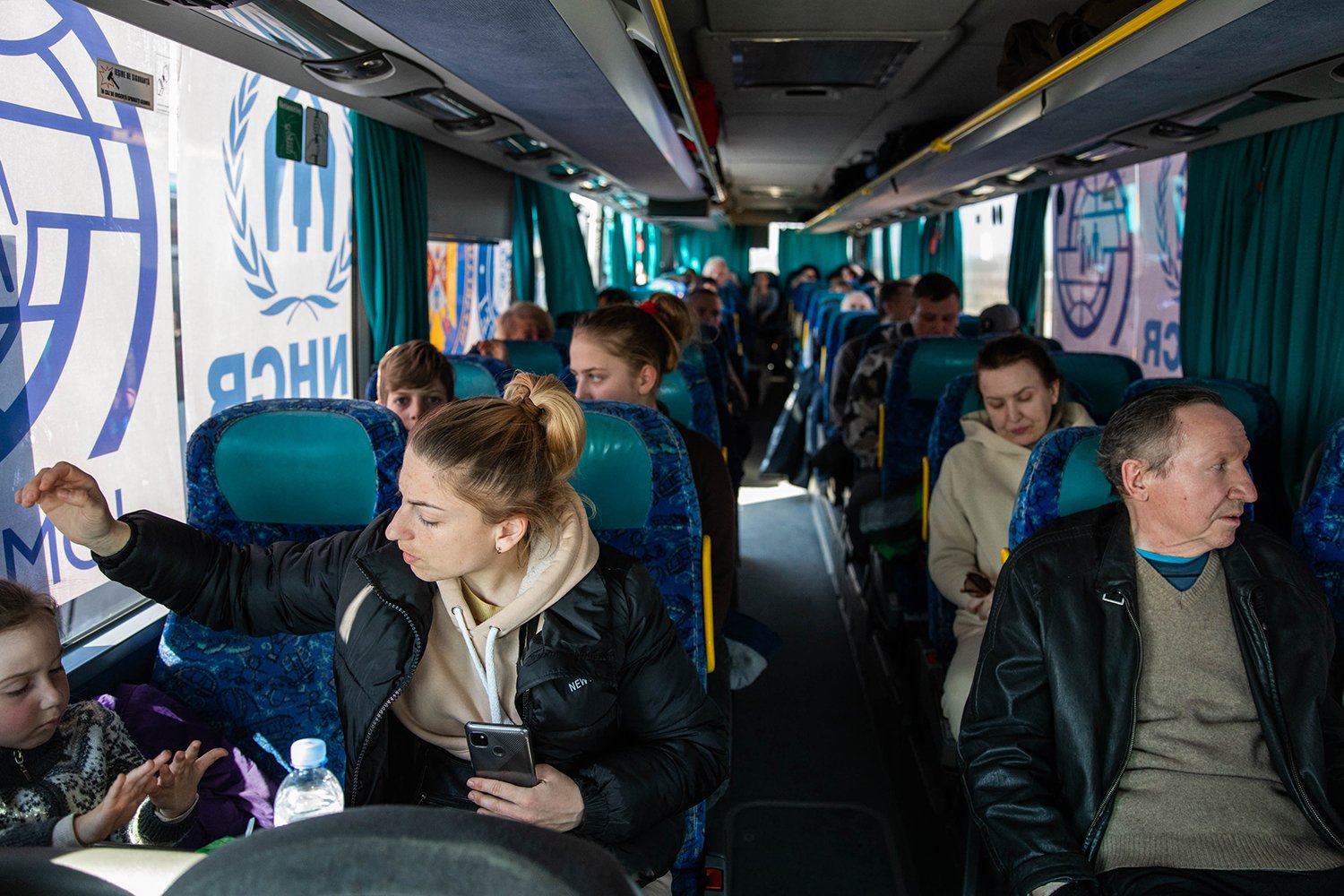 Refugees from Ukraine sit on a bus headed to Romania.