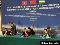 Officials from Kyrgyzstan, China, and Uzbekistan take part in a signing ceremony in Beijing on June 6 on the construction of a railway between the three countries.