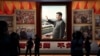 People stand in front of images of Chinese President Xi Jinping at the Museum of the Communist Party of China in Beijing in September 2022.