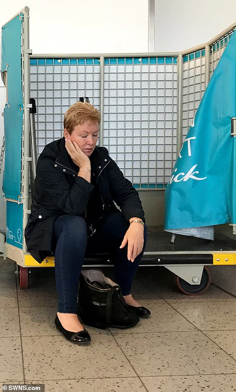 In the terminal a stranded passenger gets some rest while sat in a trolley