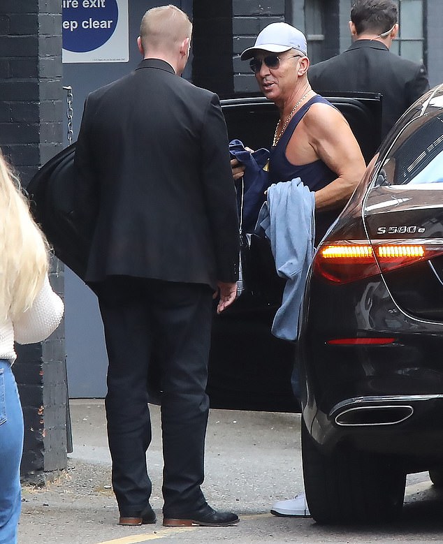 Bruno stripped down to a black gym vest before greeting onlookers with a smile as he made his way through the studio doors