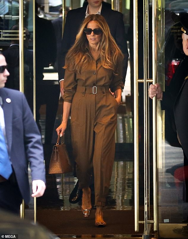 Melania donned a beige Max Mara belted jumpsuit with Roger Vivier ballet flats and carried a cognac-colored ostrich Hermés Kelly handbag