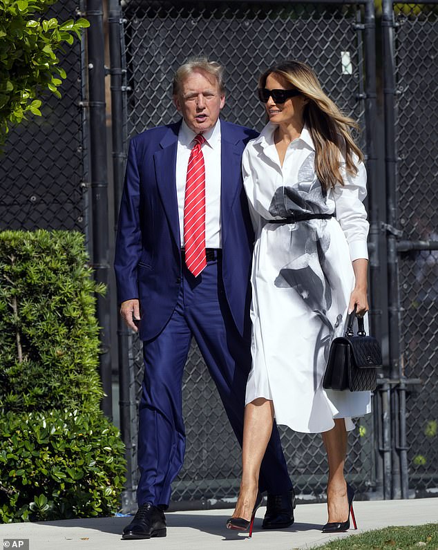 Melania Trump smiling on March 19 as she accompanies the ex-president to vote in the Florida Republican presidential primary in Palm Beach, Florida. When asked about campaigning she said 'stay tuned.'
