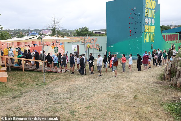 Glastonbury revellers queue up to use the facilities this morning as the festival continues