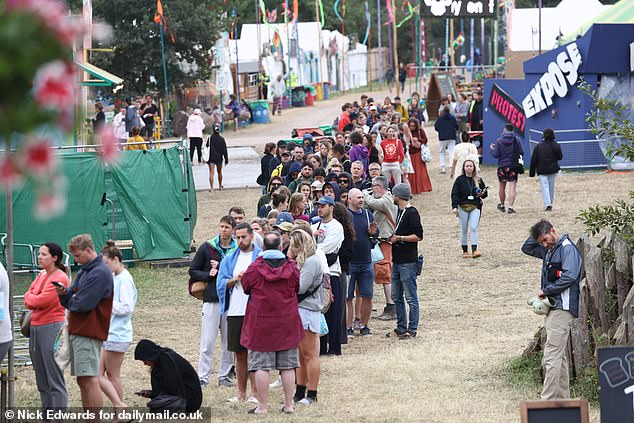Glastonbury revellers queue up to use the facilities this morning as the festival continues
