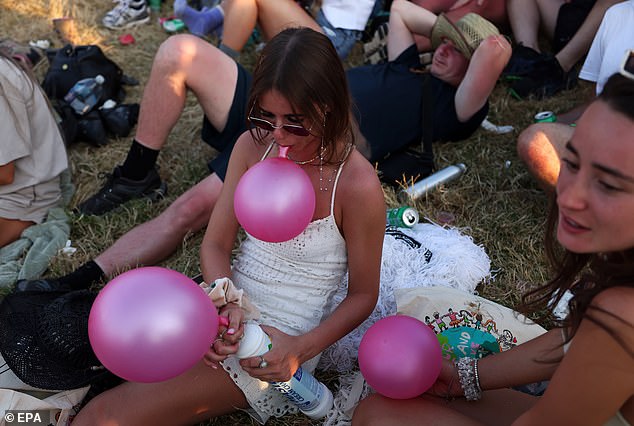 Festivalgoers at Glastonbury take 'laughing gas' at Worthy Farm on the first day of the event