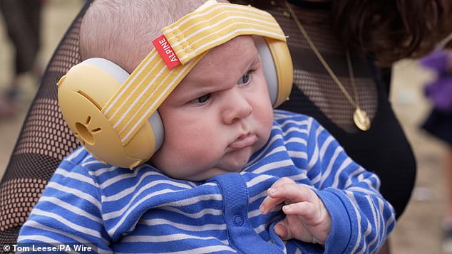 A grumpy-looking baby attending his first rave has become a Glastonbury smash hit after the dour-faced 10-week-old stole the show at Annie Mac's opening festival gig