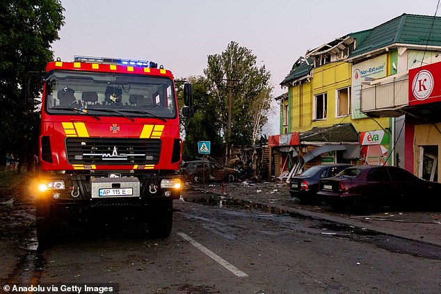 A fire engine arrives at a scene of heavy wreckage in Vilniansk after a devastating series of missile strikes