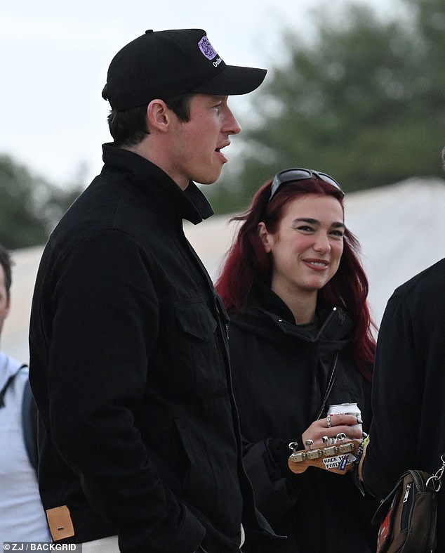 Dua Lipa was in good spirits with boyfriend Callum Turner as they enjoyed day four of Glastonbury on Sunday after she hit back at miming claims