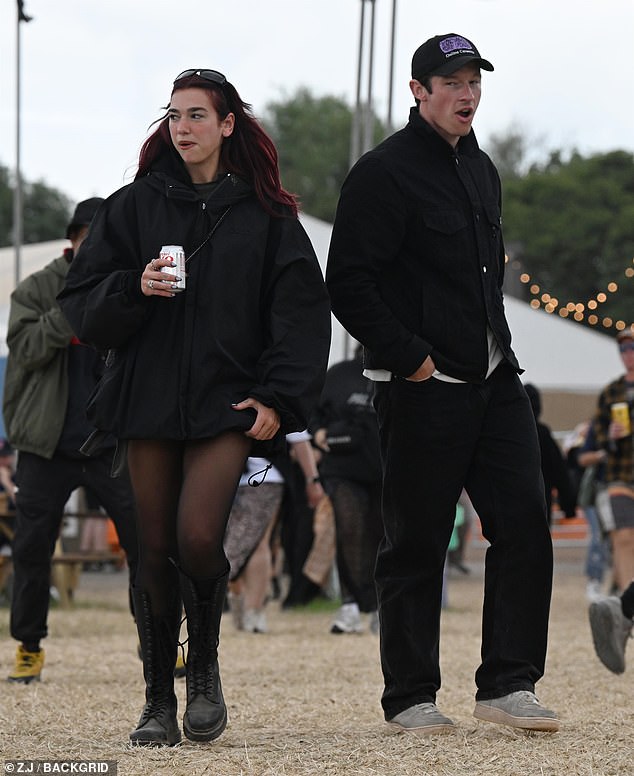 Dua put on a leggy display in a black jacket which she teamed with opaque tights and chunky lace up knee high boots while Callum opted for a cool black jacket and jeans