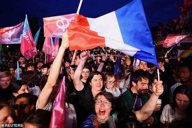 Demonstrators hold French flags and "Popular Union" flags in support of the "Nouveau Front Populaire" (New Popular Front - NFP) as they gather to protest against the French far-right