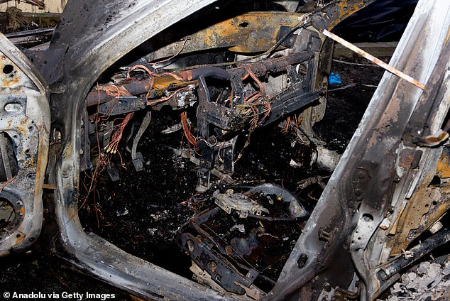 A car is pictured completely gutted after rockets were fired onto the city of Vilniansk this weekend