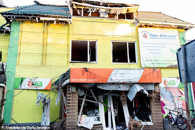 A shop pictured heavily damaged after a series of missiles landed on the city on Saturday