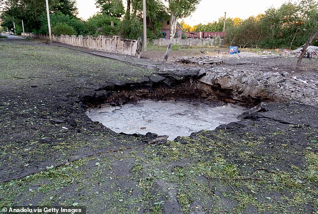 A crater filled with mud formed after the heavy strikes on Vilniansk