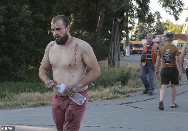 A wounded man pictured with blood streaming from his shoulder after Saturday's strikes