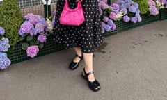 Zing Tsjeng holding a pink bag and wearing black shoes