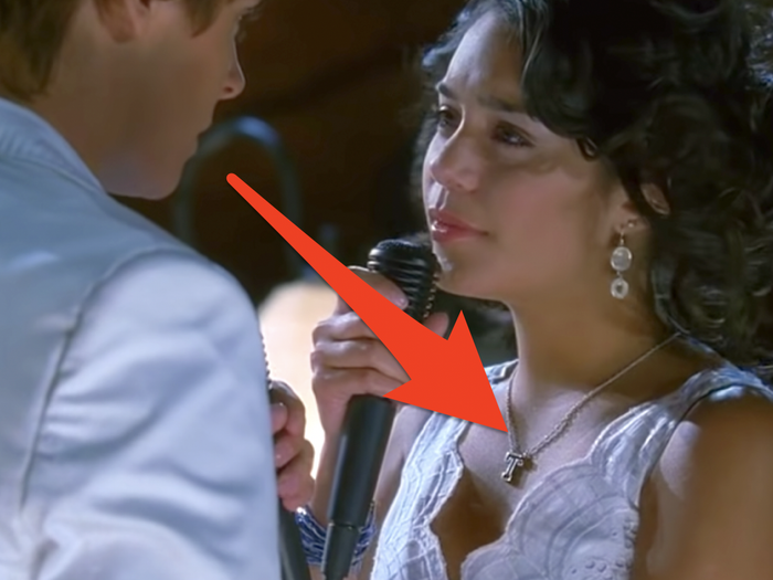 (left) red arrow pointing at harry potter's light up wand (right) red arrow pointing to gabriella's 