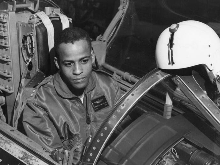 Ed Dwight wears a flight suit and sits in the cockpit of an F-104.