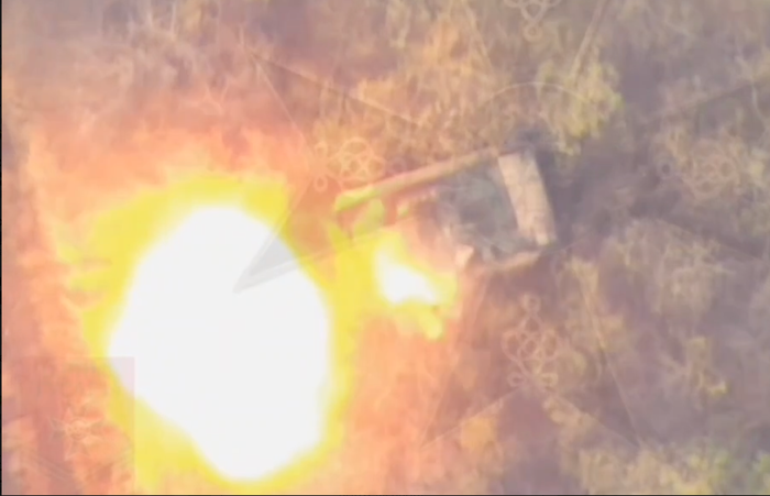 A Russian Lancet drone exploding its warhead a few feet from a Ukrainian armored vehicle.