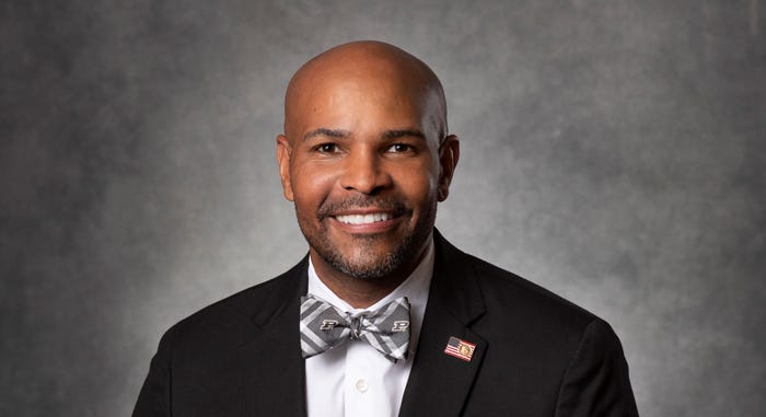 A headshot of Dr. Jerome Adams in a suit and bowtie.