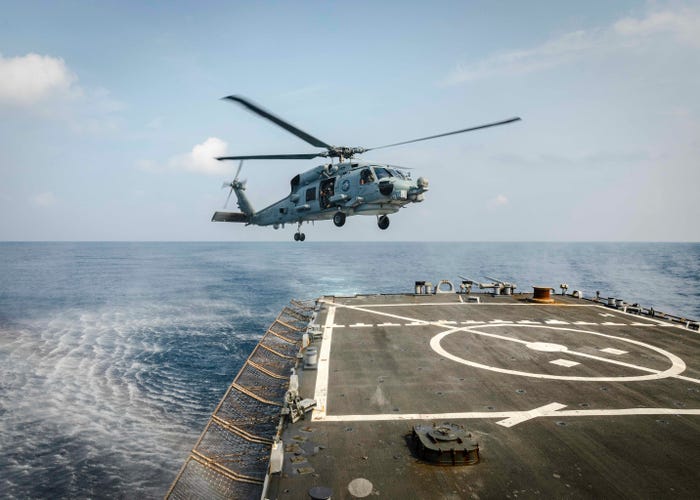 An MH-60R Sea Hawk helicopter from the Royal Australian Navy Anzac-class frigate HMAS Ballarat (FFH 155) prepares to land on the flight deck aboard the Arleigh Burke-class guided-missile destroyer USS John S. McCain (DDG 56) during flight operations.