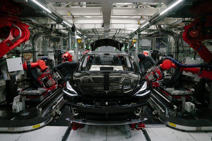 Robotics arms installing the front seats to the Tesla Model 3 at the Tesla factory in Fremont, California.