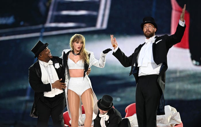 Taylor Swift is joined onstage by Travis Kelce (R), during "Taylor Swift | The Eras Tour" at Wembley Stadium on June 23, 2024 in London, England.