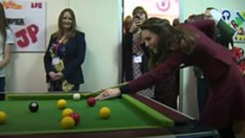 The Duchess of Cambridge shows off her pool-playing skills on a visit to a children's charity in south Wales.