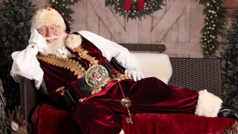 Allan Evans as Santa, smiling on a sofa