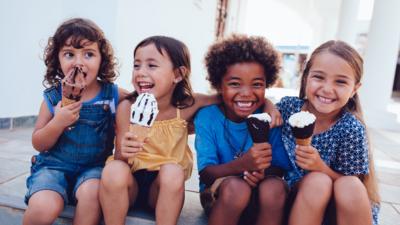 Four young children eating ice cream.