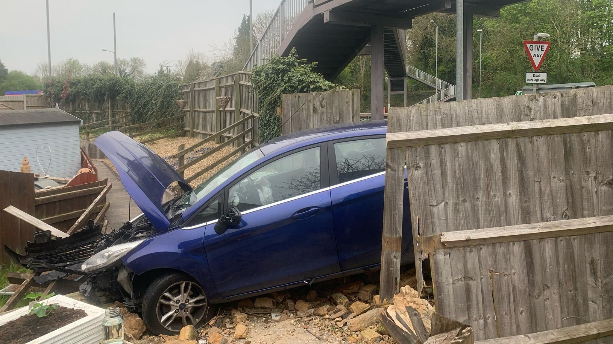 a photo of a car that had crashed into a fence
