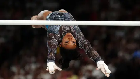 USA's Simone Biles performs on the Uneven Bars during the Artistic Gymnastics, women's qualification