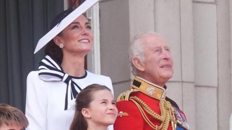 Catherine and King Charles look up to the sky from Buckingham Palace balcony
