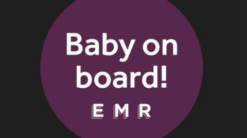 A purple, circular badge with the words Baby on Board EMR.