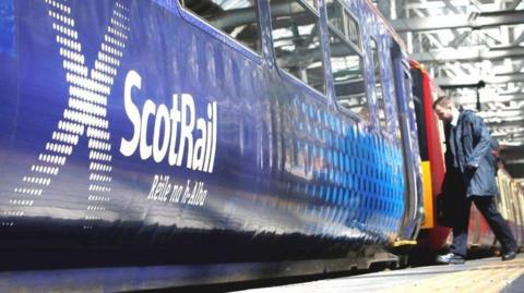 man boarding scotrail train