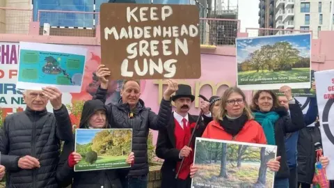 A group of protesters holding signs against the Maidenhead Golf Course development. One says 