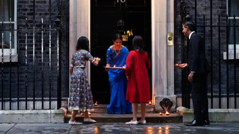 Getty Images  Rishi Sunak with his wife Akshata Murty and their daughters Anoushka and Krishna putting candles outside of No 10 to mark Diwali 