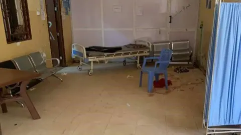 A hospital bed and screen in the corridor after the attack