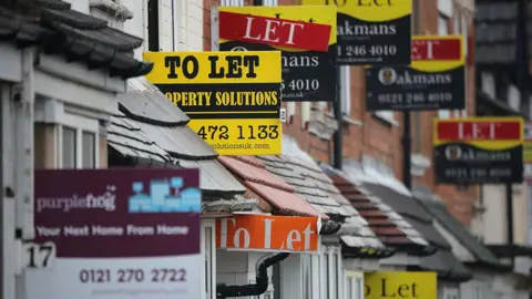 Getty Images Host of lettings signs outside terraced homes