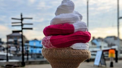 Knitted ice cream with cone made from white, red and brown yarn