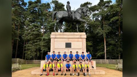 The Albert memorial in Windsor Park with the riders sitting on the steps for the photo