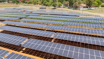Photo depicts of Solar panels on tomato field for agriculture, development of rural areas and cities in Africa.