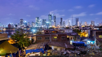 Photo depicts Night skyline of Mumbai photographed from Worli fort with the village in the foreground. Encroachment and development in the same frame.