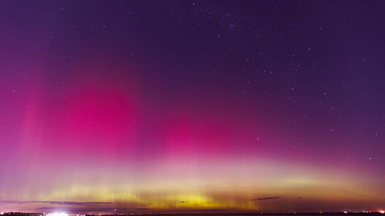 The Melbourne night sky illuminated with pinks and purples during an Aurora Australis.