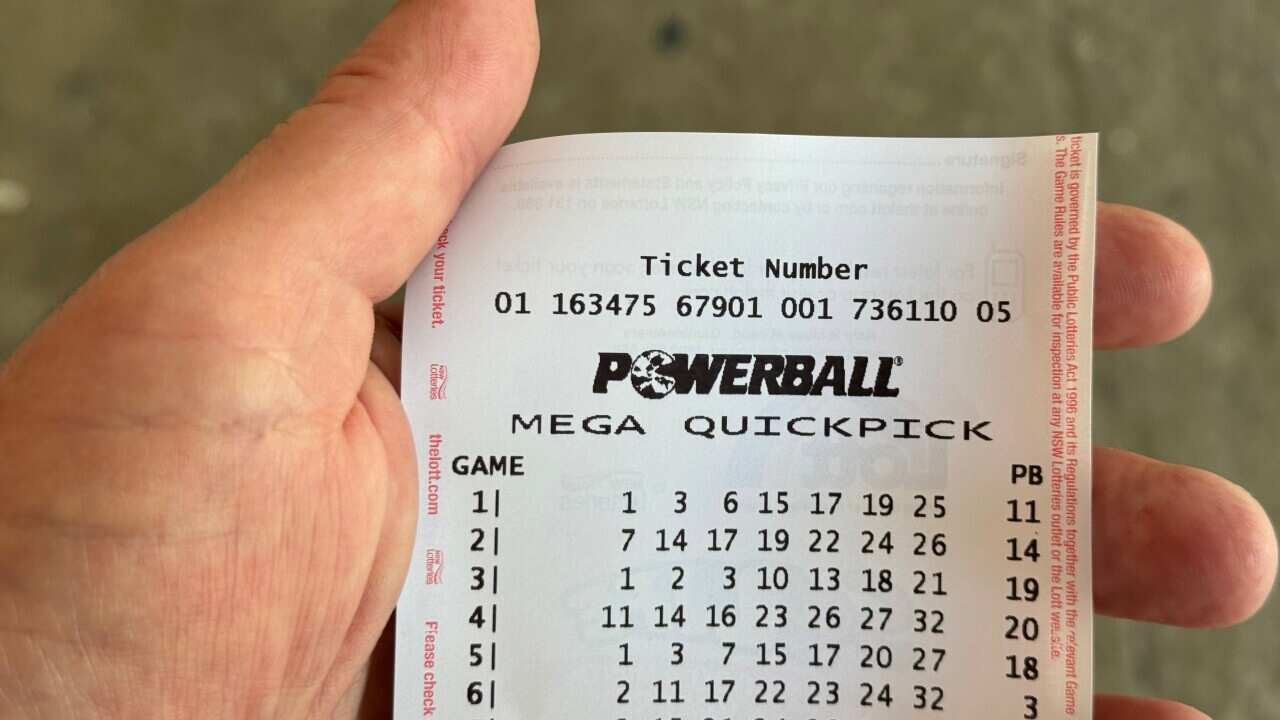 A Powerball ticket in someone's hand