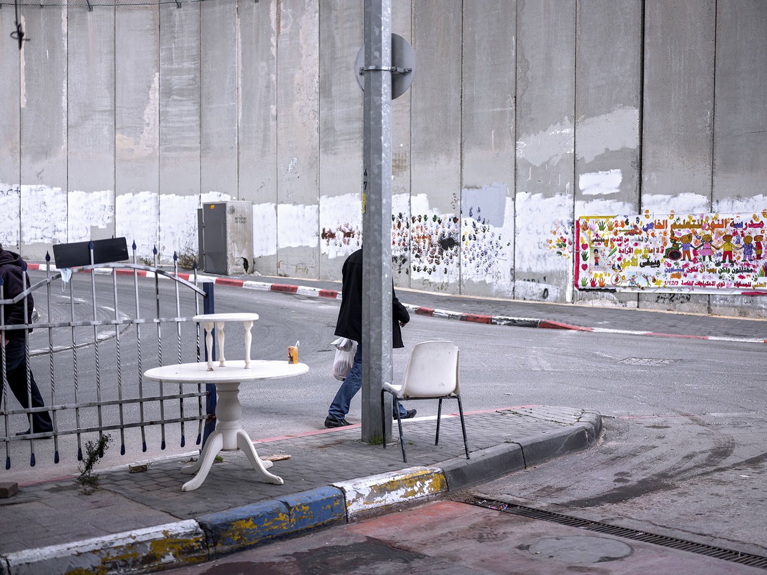  Palestinians walk by a section of the Israeli separation barrier in the West Bank village of Abu Dis on the outskirts of Jerusalem, Jan. 31, 2022. (AP Photo/Oded Balilty) 