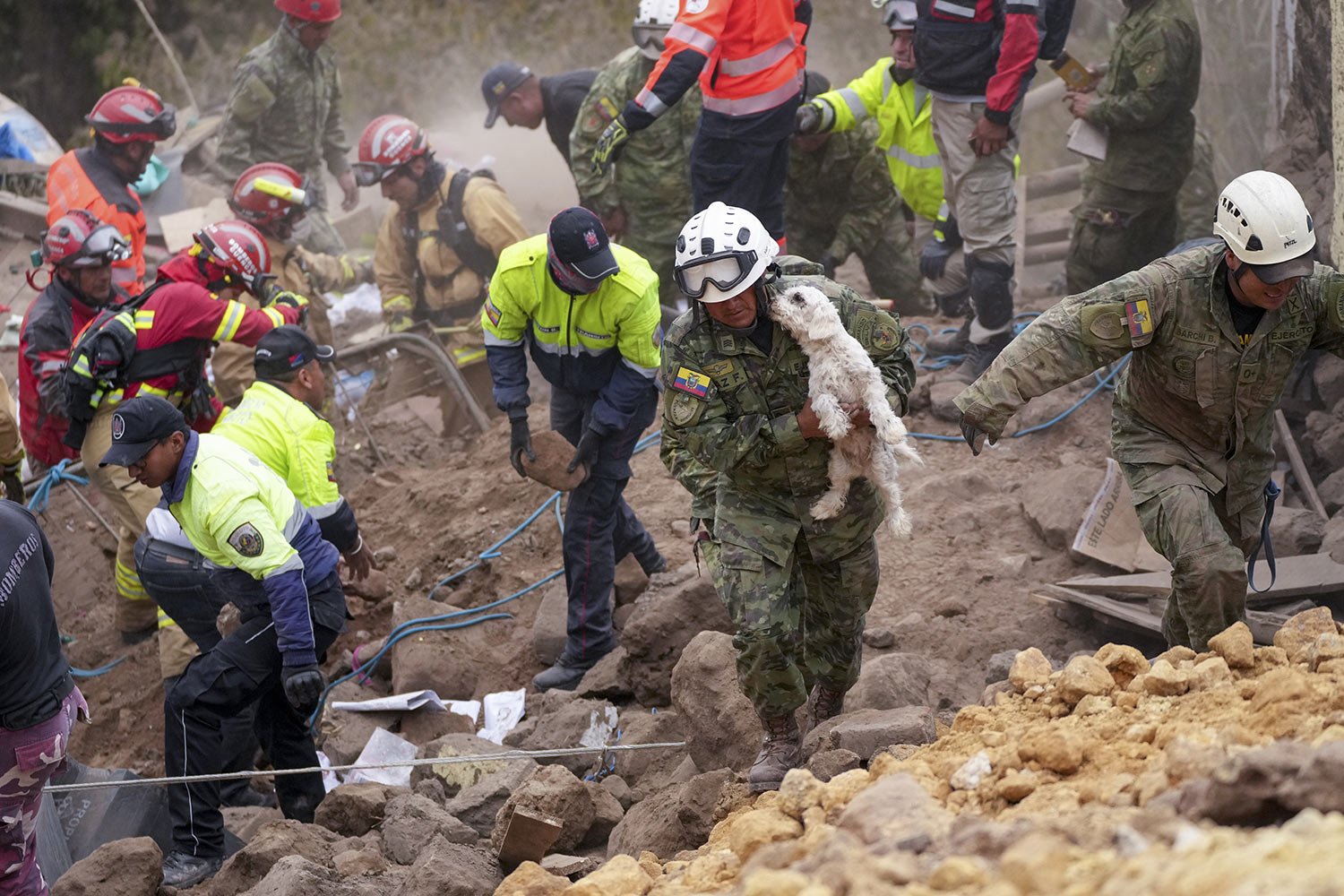  A soldier carries a dog rescued from the rubble of buildings destroyed by a deadly landslide that buried dozens of homes, in Alausi, Ecuador, March 27, 2023. (AP Photo/Dolores Ochoa) 